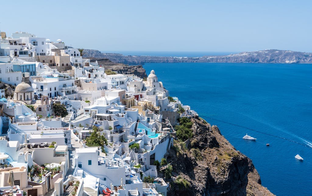 Beautiful Santorini houses overlooking the Aegean Sea. Embodying the relaxed pace of the best Europe travel itinerary.