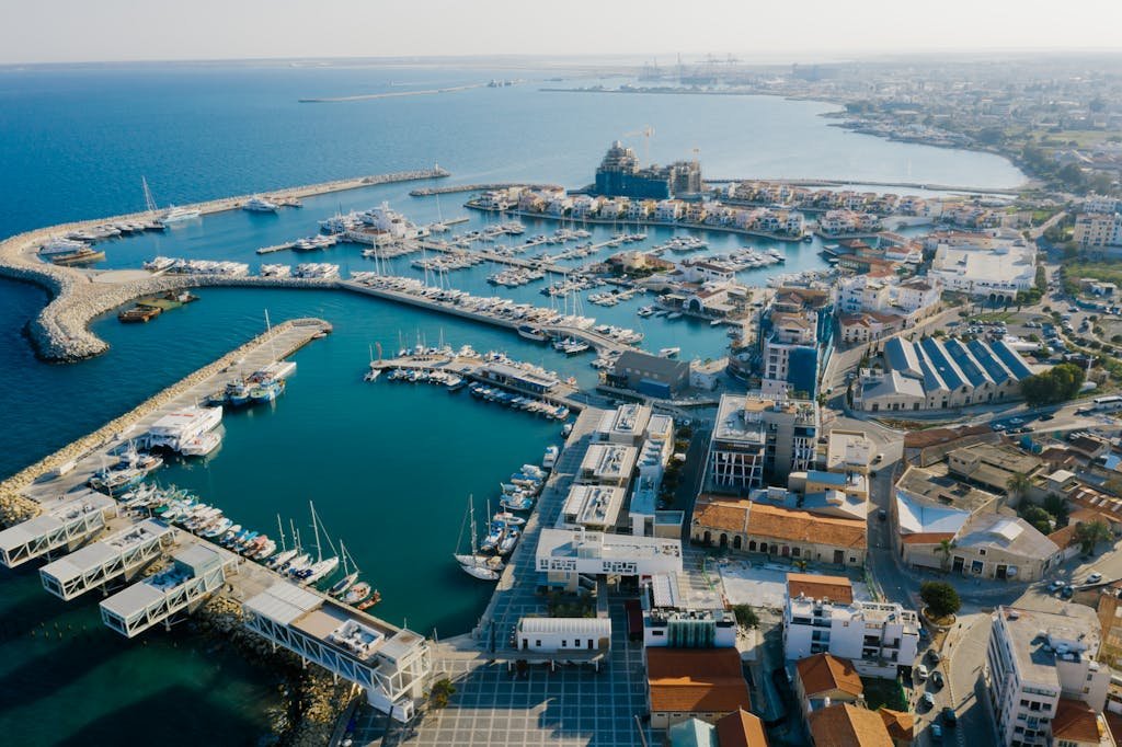 Stunning aerial view of Limassol Marina, things to see when traveling to Cyprus featuring yachts and urban landscape.